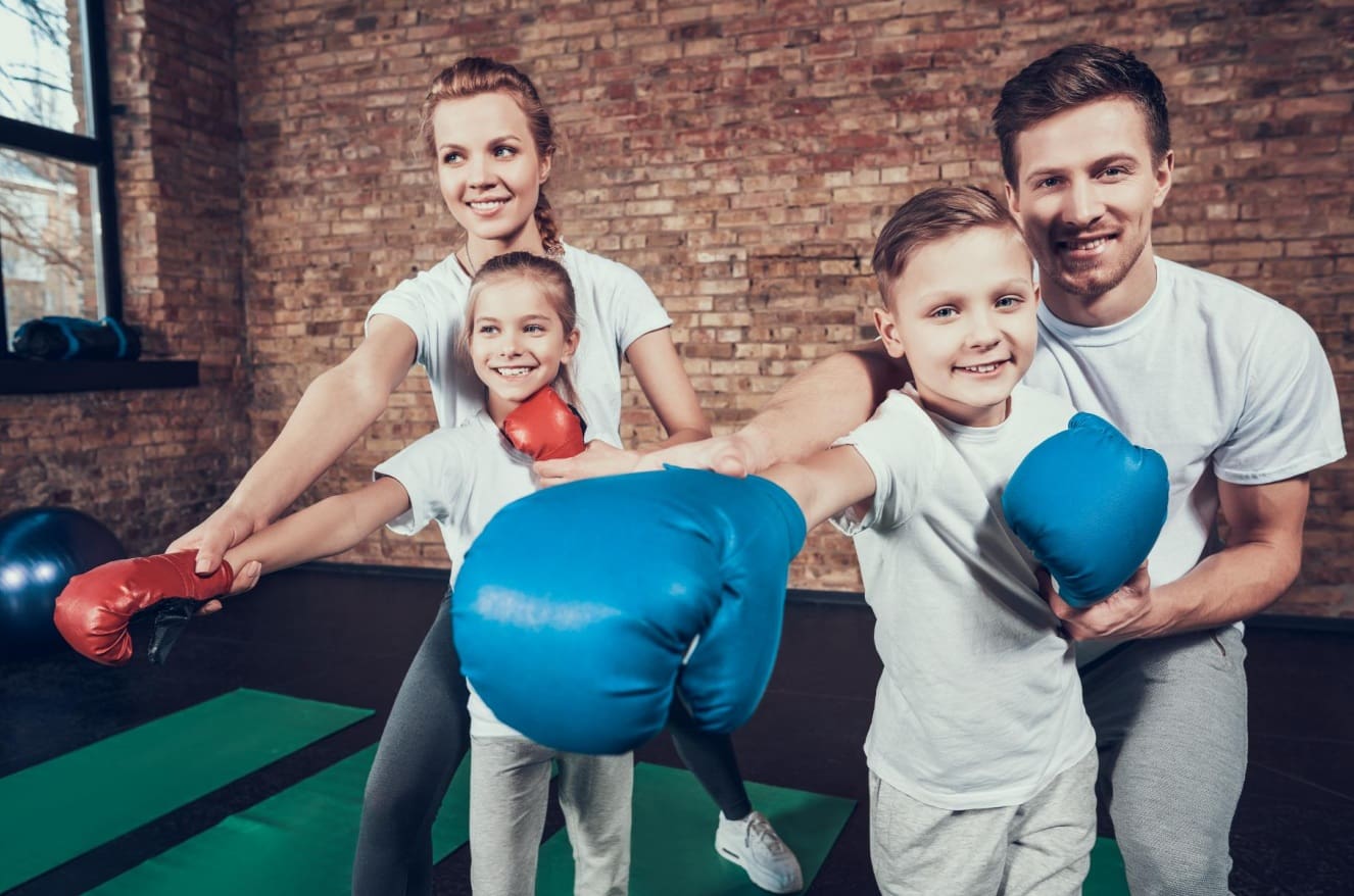 Kids' beginner boxing classes teach basic punches and strength training through high-intensity activities like focus pads, punching bags, and jump rope, helping young participants build confidence, self-esteem, balance, and lower-body strength while practicing at their own pace under the guidance of skilled instructors in a safe, structured boxing course that may include light sparring and injury prevention techniques.