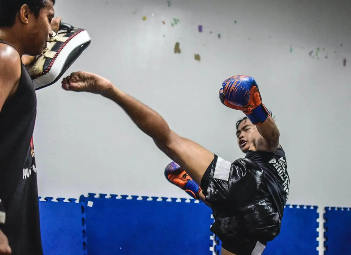 Teen practicing kicks
