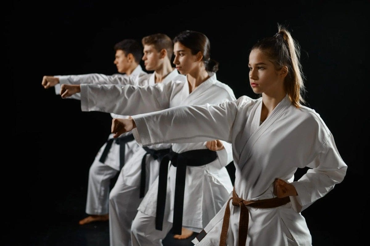 Women and Men training in a martial arts session