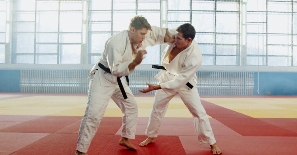 Two practitioners practicing grip control during martial arts fundamentals training