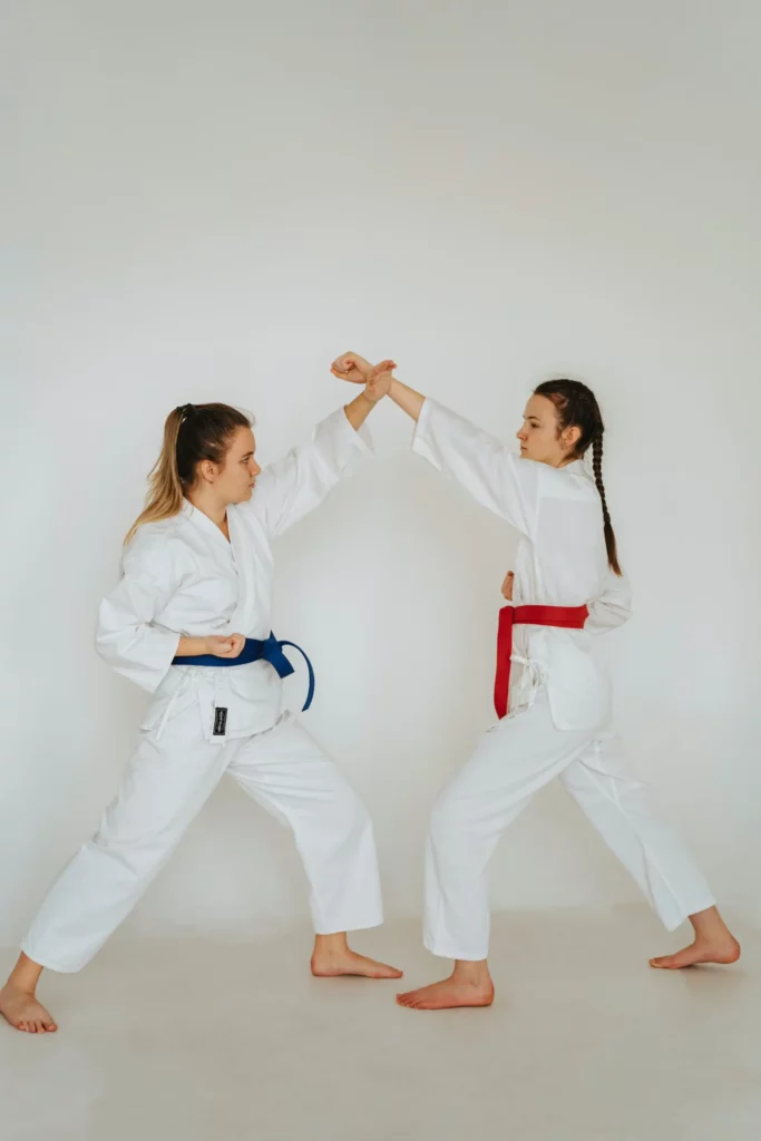 Two students practicing wrist defense during beginner martial arts drills